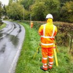 Land Surveyors on the road doing geometric levelling